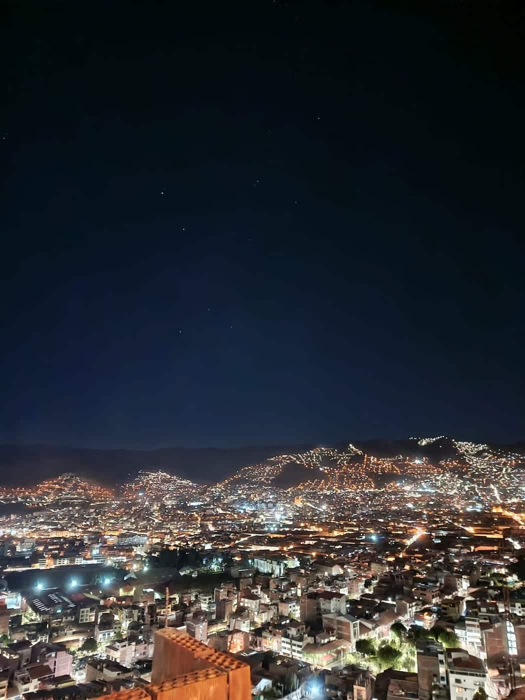 The Cusco night skyline, the cathedral towers lit against the dark Andean sky.